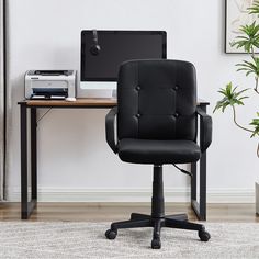 a black office chair sitting in front of a computer desk with a printer on it