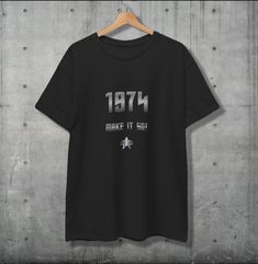 Celebrate a milestone birthday in true Star Trek style! This unique 1974 Make it 50! T-shirt is inspired by Captain Picard's iconic phrase, "Make it so," with a clever twist for anyone hitting the big 5-0. Featuring bold text, "1974 Make it 50!" and a subtle Star Trek communicator badge, this shirt is a must-have for sci-fi fans who want to boldly embrace their 50th birthday. Whether you're shopping for a dedicated Trekkie or a sci-fi enthusiast, this shirt is the perfect gift for those who love Star Trek Birthday, Star Trek Communicator, Captain Picard, Turning 50, Big 5, Bold Text, Milestone Birthday, High Quality Design, 50th Birthday