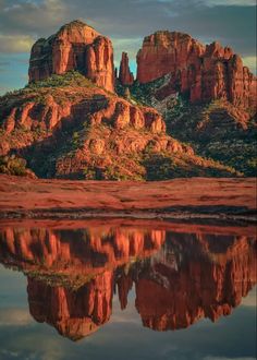 the red rocks are reflected in the still water at sunset, near sedona