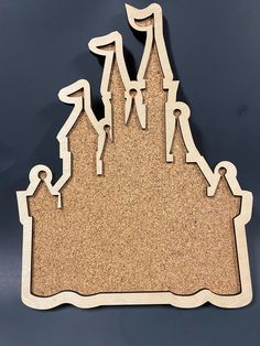 a wooden cutout of a castle with people on it