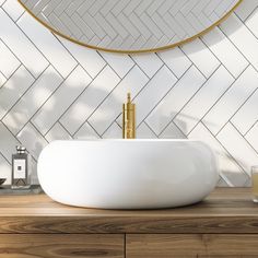 a bathroom sink sitting on top of a wooden counter next to a white tiled wall