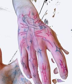 a person's hand with pink and blue ink on it