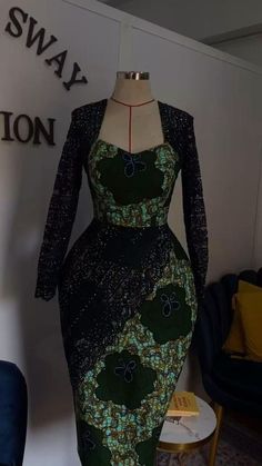 a mannequin dressed in a green and black dress