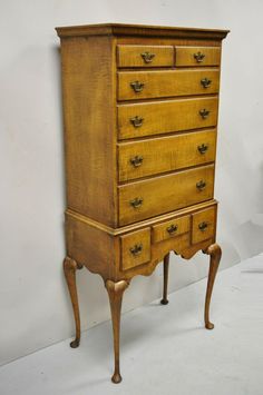 an old wooden dresser sitting on top of a white floor