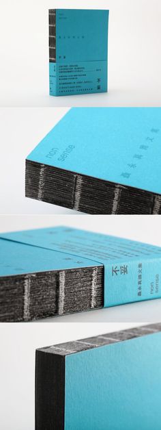 two books are stacked on top of each other, one is blue and the other is black