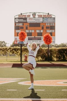 a cheerleader is performing on the football field