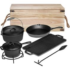 an assortment of pots and pans are shown in front of a wooden box with tongs