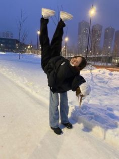 a person is doing a handstand in the snow