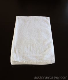 a white towel sitting on top of a black table