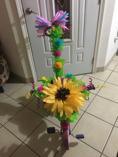 a vase filled with flowers sitting on top of a tiled floor next to a door