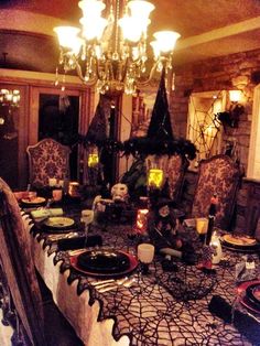 the dining room table is set for halloween dinner