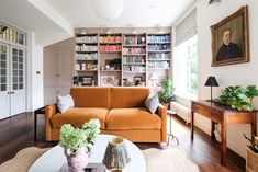 a living room filled with furniture and bookshelves