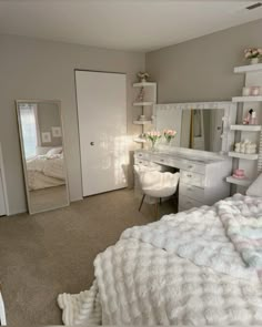 a bedroom with a bed, desk and mirror