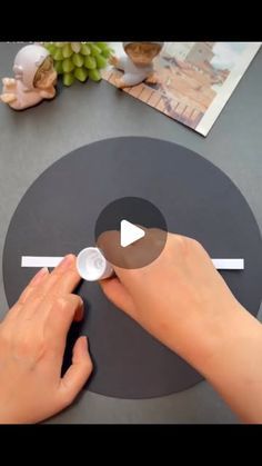 a person is making a clock out of paper