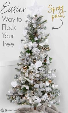 a white christmas tree with silver and gold ornaments on it, next to a sign that says easier way to flock your tree