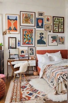 a bedroom with lots of pictures on the wall