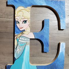 the letter f is painted with an image of frozen princess in blue and white dress