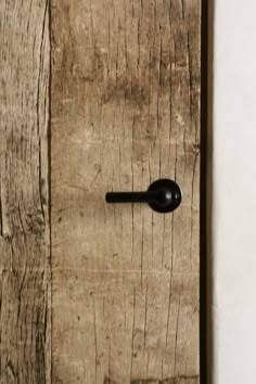 an old wooden door with a black handle