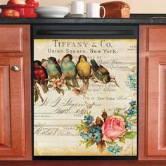 a kitchen cabinet door with birds and flowers on it