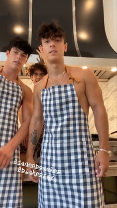 two men in aprons standing next to each other