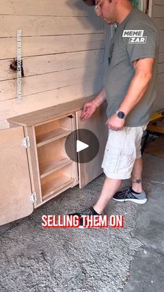 a man standing in front of a cabinet with the words selling them on it's side