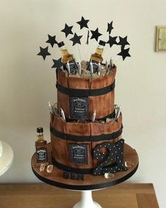 a three tiered cake decorated with liquor bottles and stars