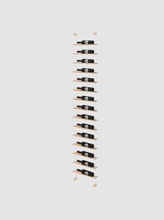 an array of black and white wine bottles are arranged in the shape of a rack