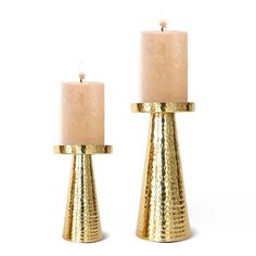 two gold candles sitting on top of each other