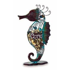 a metal sea horse sculpture with corks on it's tail and the word corb written in cursive writing