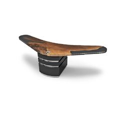 a wooden bench sitting on top of a black stand up paddleboard holder in front of a white background