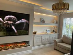 a living room filled with furniture and a flat screen tv mounted to the wall next to a fire place