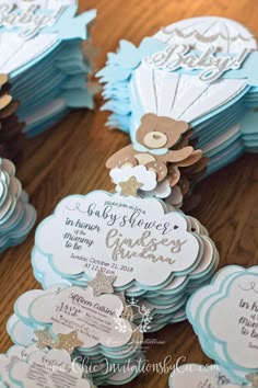 blue and white baby shower favors with teddy bears on them, sitting on a wooden table