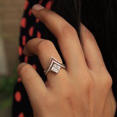 a woman's hand with a diamond ring on it