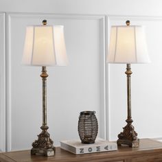 two lamps sitting on top of a wooden table