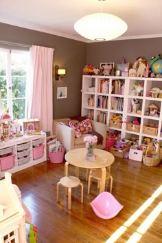 a child's playroom with toys, bookshelves and other items in it