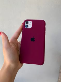 a person holding an iphone in their left hand with the back cover removed from it