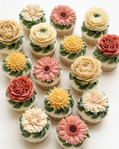 cupcakes decorated with flowers on top of each other