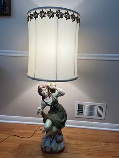 a lamp that is on top of a wooden floor