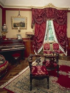 an old fashioned living room with red curtains