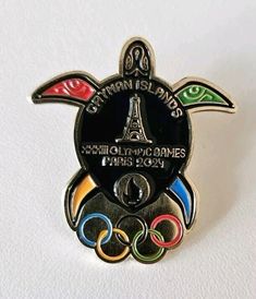 a pin with the olympic emblem on it