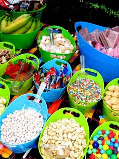 several buckets filled with different types of candy and candies next to each other