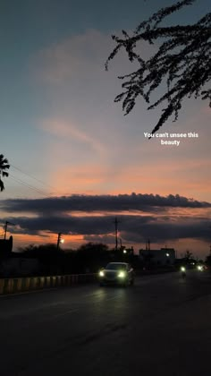 cars driving down the road at dusk with an inspirational quote written on the sky above them