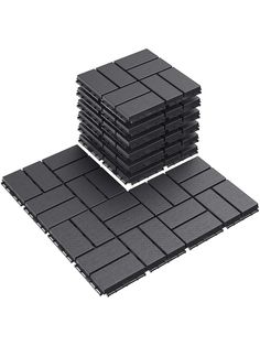 a stack of black tiles sitting on top of each other