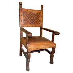 a wooden chair with leather upholstered back and arm rests on an isolated white background