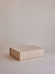 a striped box sitting on top of a white table