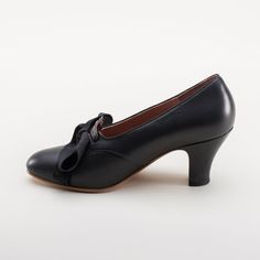 Glamour and practicality pair perfectly with the beautiful Hazel slip-on pumps. Glossy leather, an almond-shaped toe, 2.5 in / 6.35 cm repro heel, and the cutest little ribbon bow tie make these beautiful shoes perfect for the 1920s all the way through to 1950. [custom tab] Sizing Size Trends Runs true to size for most customers. Width Regular (B) width Size Chart Materials Color Black Upper 100% Calf Leather Lining Pigskin leather Sole Leather Heel Leather Covered Heel Height 2.5 inch / 6.35 cm 1950s Shoes, Ribbon Bow Tie, American Duchess, Vintage Pumps, Slip On Pumps, Black Pumps Heels, Rich Man, The 1920s, Black American