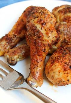 a plate with some chicken on it next to a fork