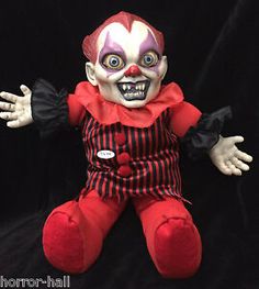 a creepy clown doll is posed on a black background