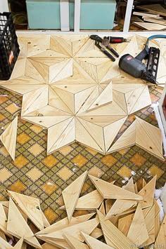 a table that has some wood pieces on top of it and tools in the background