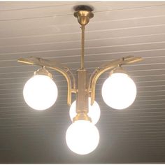 three lights hanging from the ceiling in a room